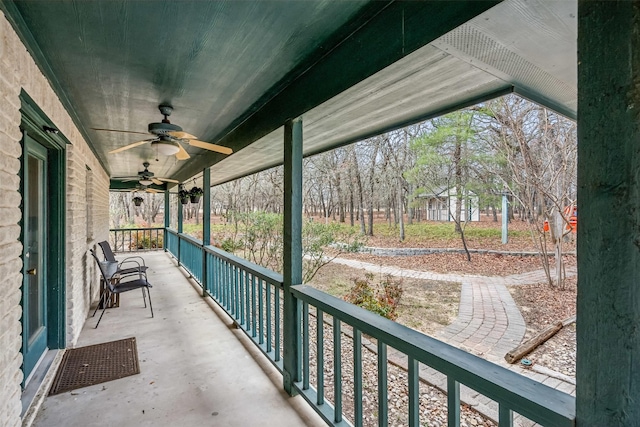 balcony with ceiling fan and a porch