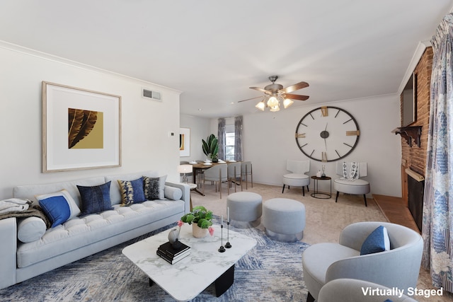 living room featuring crown molding, ceiling fan, and a brick fireplace