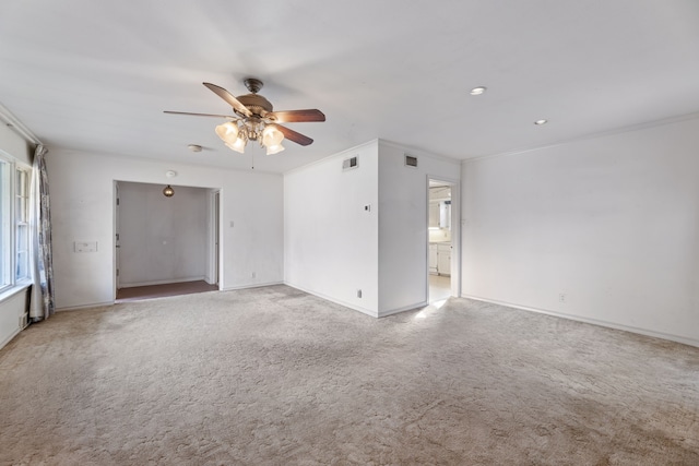 unfurnished room with crown molding, light carpet, and ceiling fan