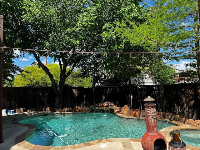 view of swimming pool featuring an in ground hot tub and pool water feature