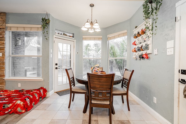 tiled dining space featuring a chandelier