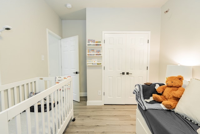 bedroom with a closet and light hardwood / wood-style flooring