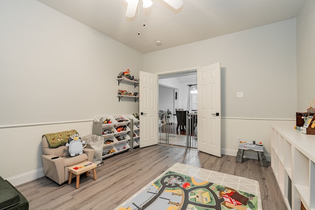 sitting room with ceiling fan and light hardwood / wood-style flooring