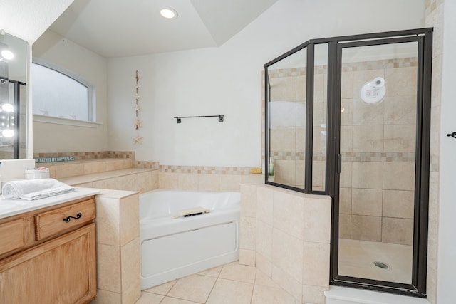 bathroom with separate shower and tub, tile patterned flooring, tile walls, and vanity