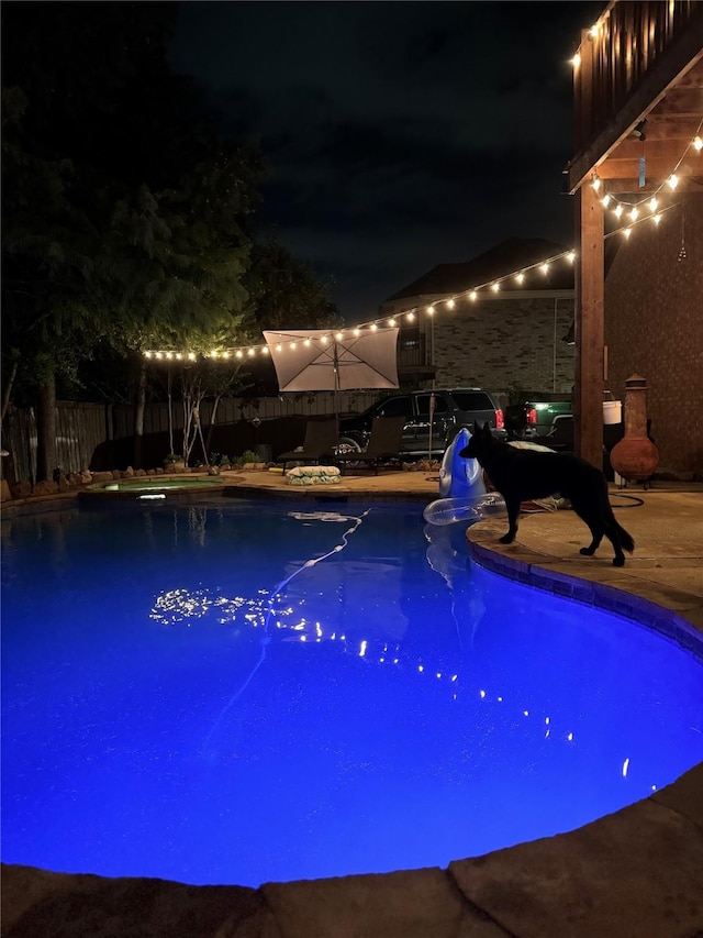 view of pool at night