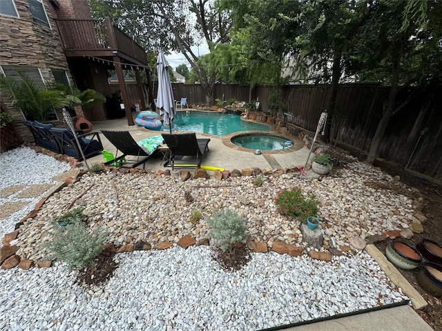 view of pool featuring an in ground hot tub and a patio