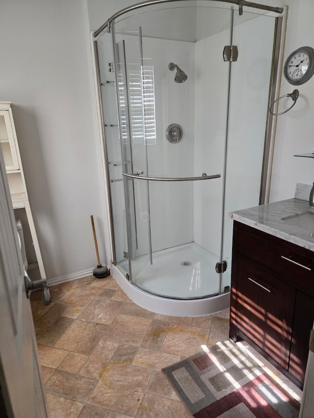 bathroom with a shower with door and vanity