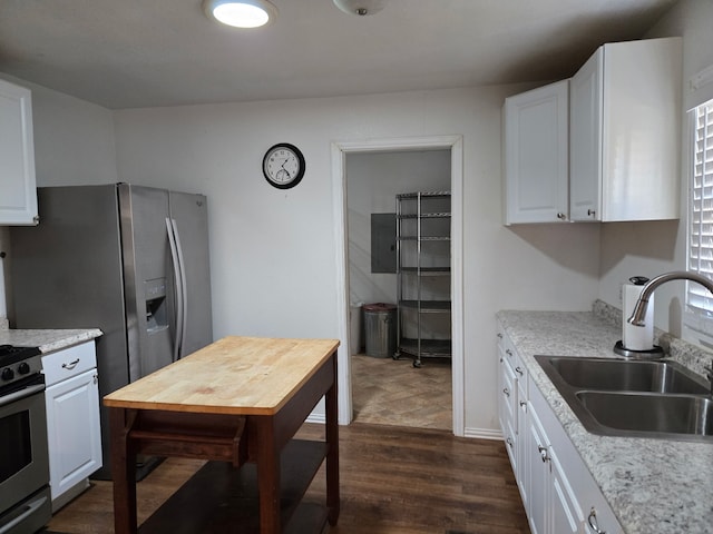 kitchen with white cabinetry, sink, dark wood-type flooring, and gas stove