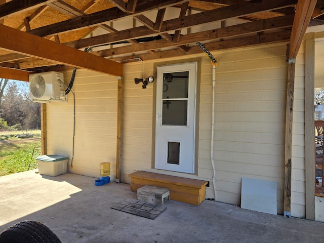 property entrance featuring ac unit and a patio area