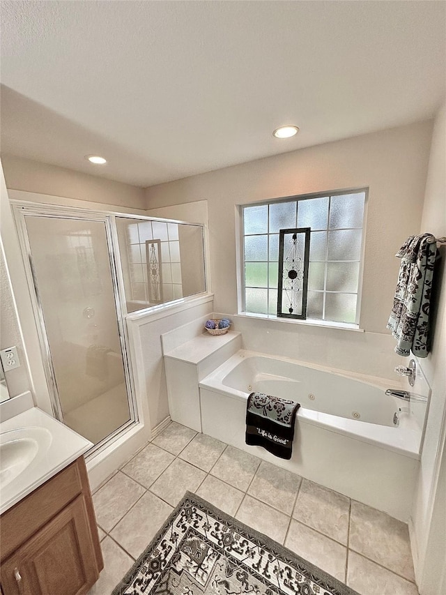 bathroom with shower with separate bathtub, tile patterned flooring, and vanity