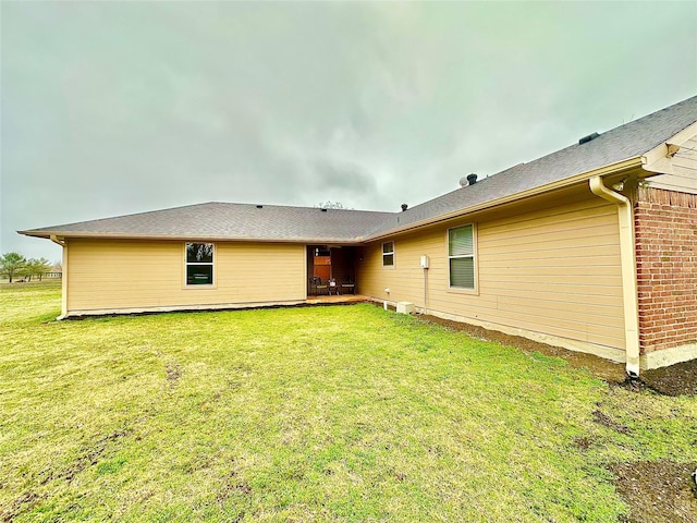 rear view of house with a lawn