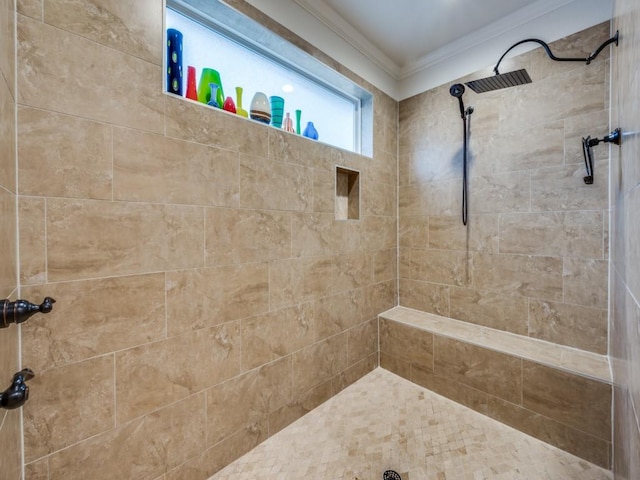 bathroom featuring a tile shower and crown molding