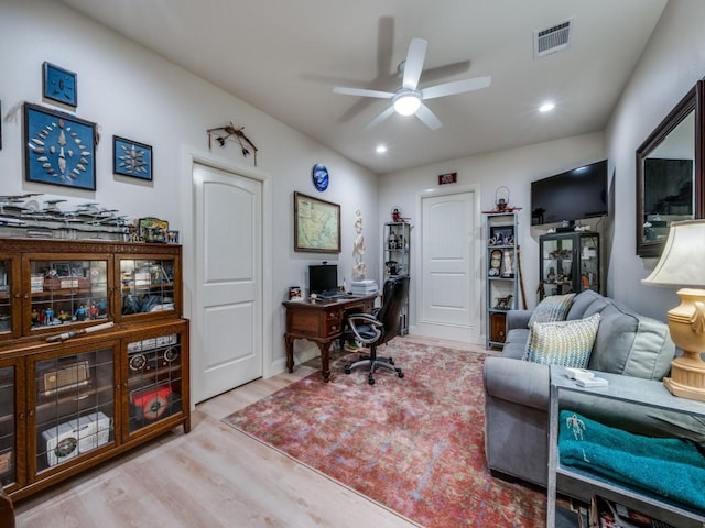 home office with ceiling fan and light wood-type flooring