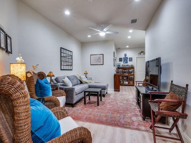 living room featuring ceiling fan and light hardwood / wood-style floors