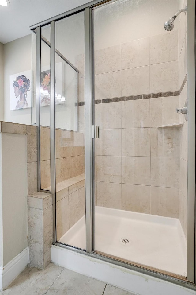 bathroom featuring a shower with door