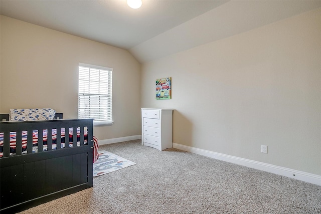 carpeted bedroom featuring lofted ceiling