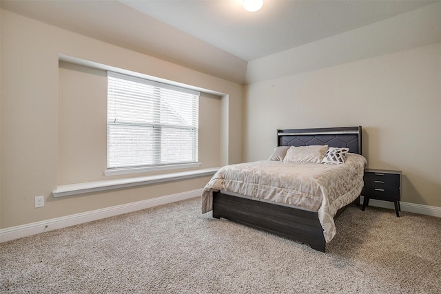 carpeted bedroom with lofted ceiling