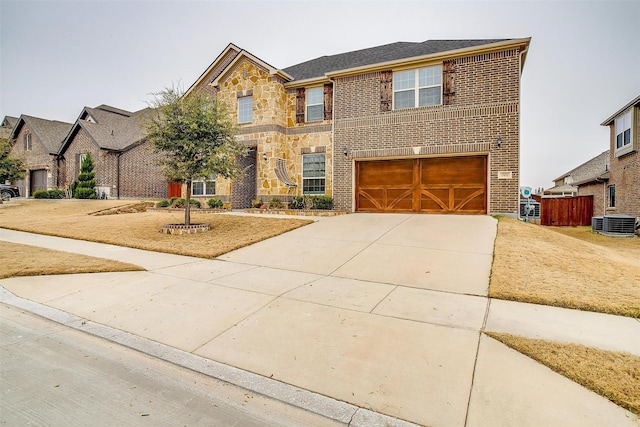 view of front of house with a garage and central AC