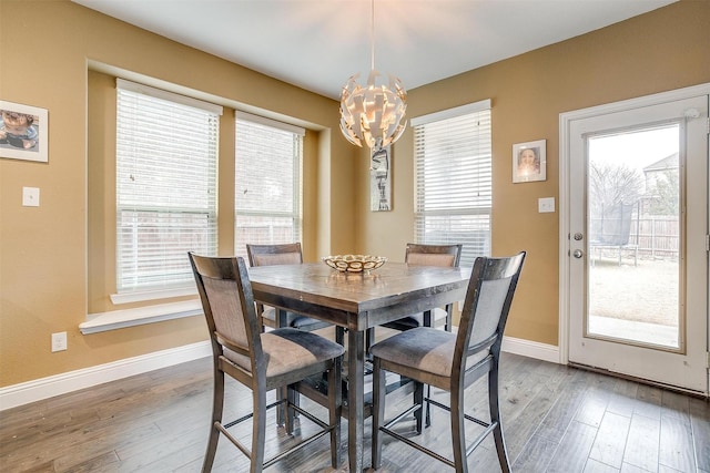 dining room with an inviting chandelier and hardwood / wood-style flooring