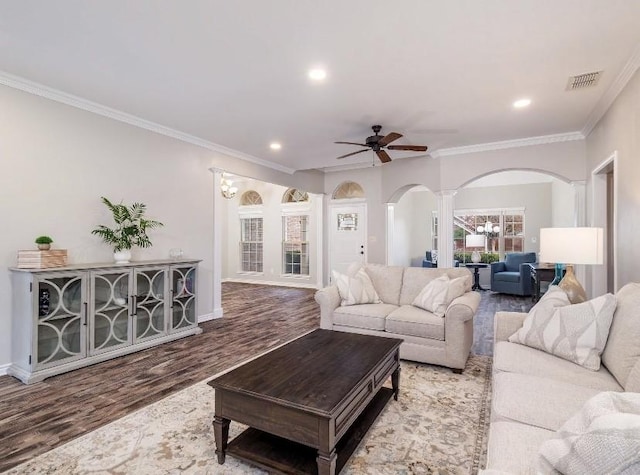 living room with hardwood / wood-style flooring, ornamental molding, decorative columns, and ceiling fan