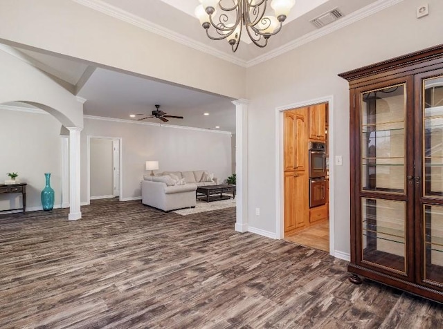 living room featuring dark hardwood / wood-style flooring, crown molding, ceiling fan with notable chandelier, and decorative columns