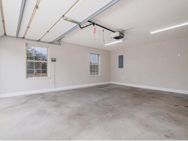 garage with a garage door opener and electric panel