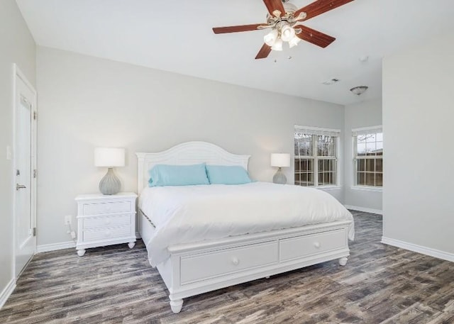 bedroom with ceiling fan and dark hardwood / wood-style flooring