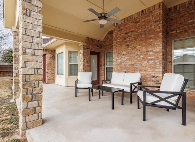 view of patio with an outdoor living space and ceiling fan