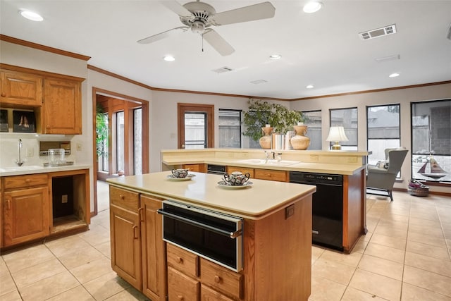 kitchen with sink, light tile patterned flooring, dishwasher, and a kitchen island