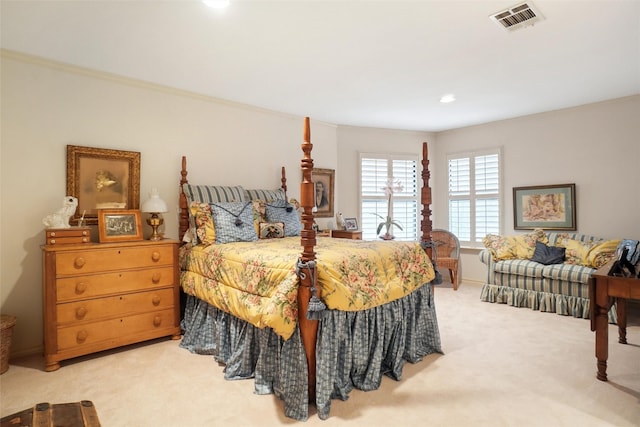 bedroom with crown molding and light colored carpet