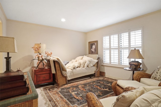 bedroom with ornamental molding and wood-type flooring