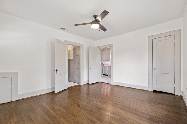 unfurnished bedroom with dark hardwood / wood-style floors and ensuite bathroom