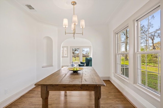 dining room with wood-type flooring and a chandelier