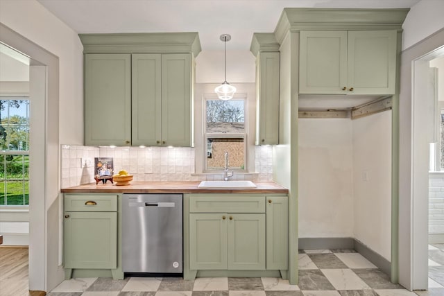 kitchen with wood counters, sink, dishwasher, pendant lighting, and backsplash