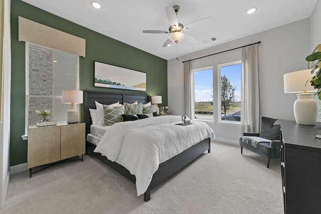 bedroom with ceiling fan and light carpet