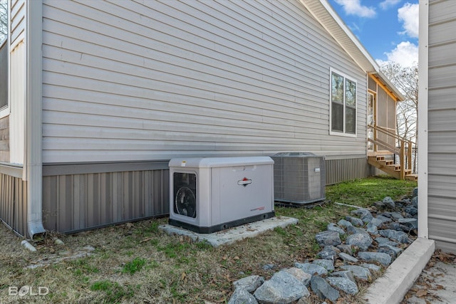 view of side of property featuring central AC and ac unit