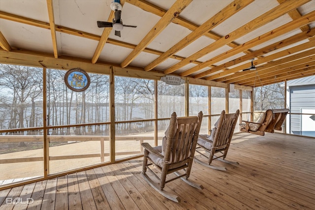 unfurnished sunroom featuring ceiling fan and a wealth of natural light