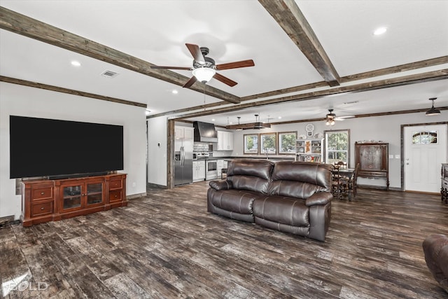 living room featuring beamed ceiling, ceiling fan, and dark wood-type flooring