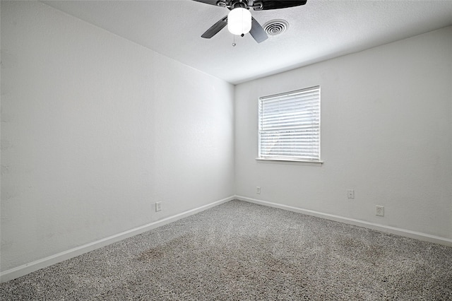 carpeted spare room with ceiling fan, a textured ceiling, visible vents, and baseboards