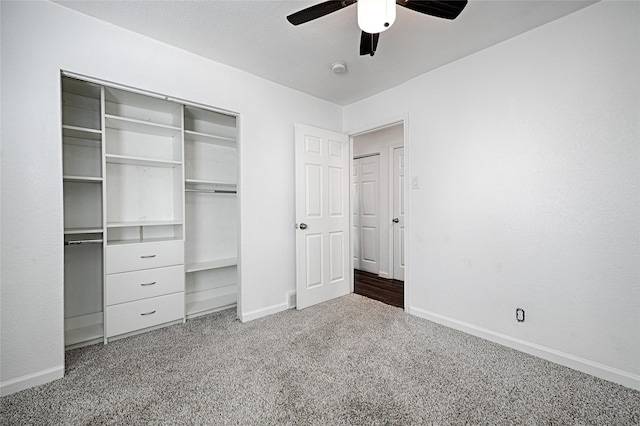 unfurnished bedroom featuring carpet, baseboards, ceiling fan, and a closet