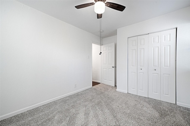 unfurnished bedroom with a ceiling fan, carpet, a closet, and baseboards