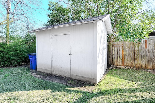 view of shed featuring fence