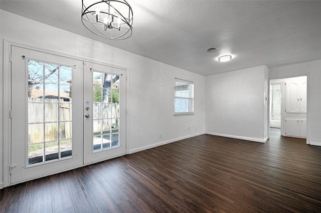 interior space with dark wood-style floors, french doors, and a healthy amount of sunlight