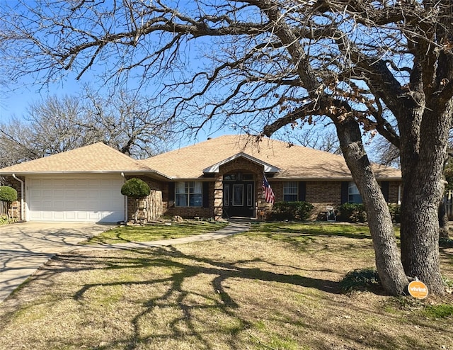 ranch-style house featuring a garage and a front lawn