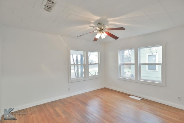 empty room with hardwood / wood-style flooring and ceiling fan