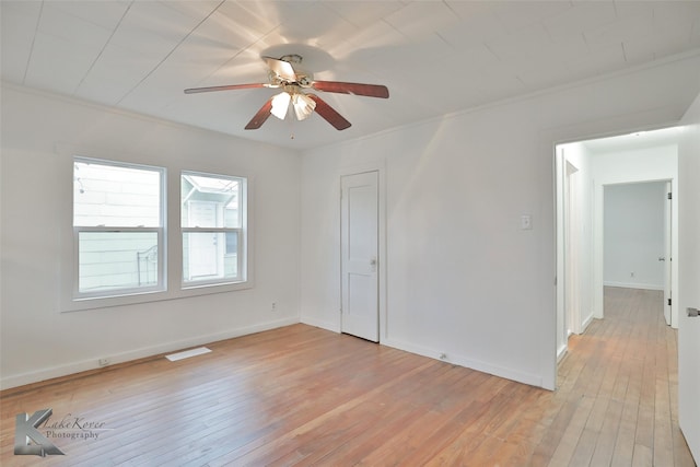 spare room with crown molding, ceiling fan, and light hardwood / wood-style floors