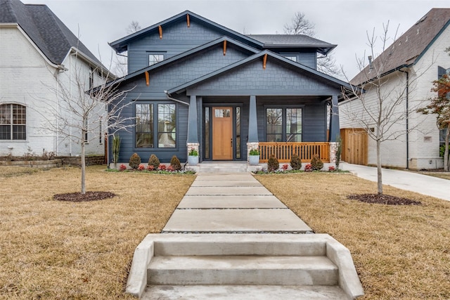 view of front of home featuring covered porch and a front yard