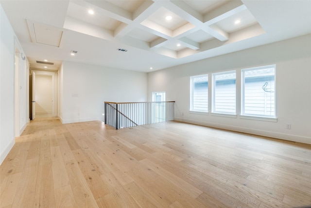 unfurnished room with coffered ceiling, light hardwood / wood-style floors, and beam ceiling