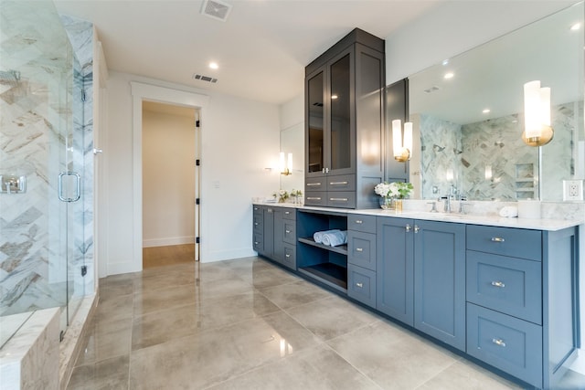 bathroom featuring vanity and a shower with shower door