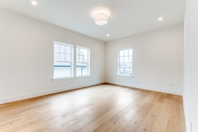 spare room with light hardwood / wood-style flooring